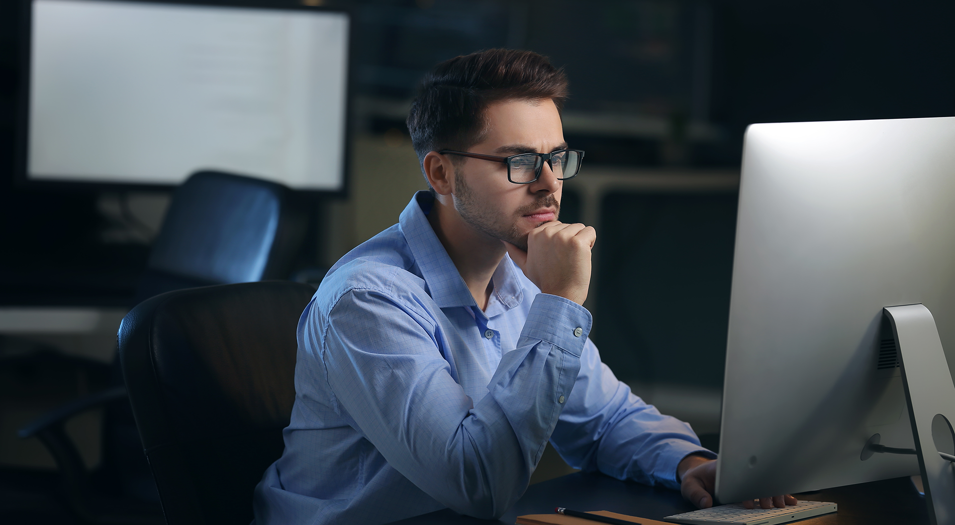 Man sitting at desk in front of computer screen