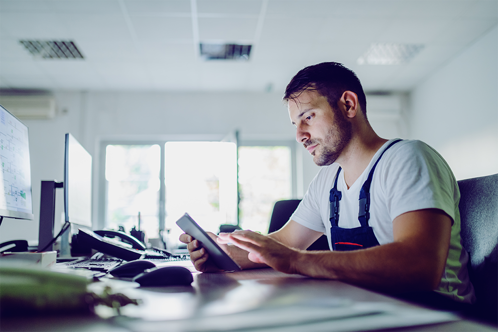 Man with a tablet - Metering as a Service guarantees the security of processing