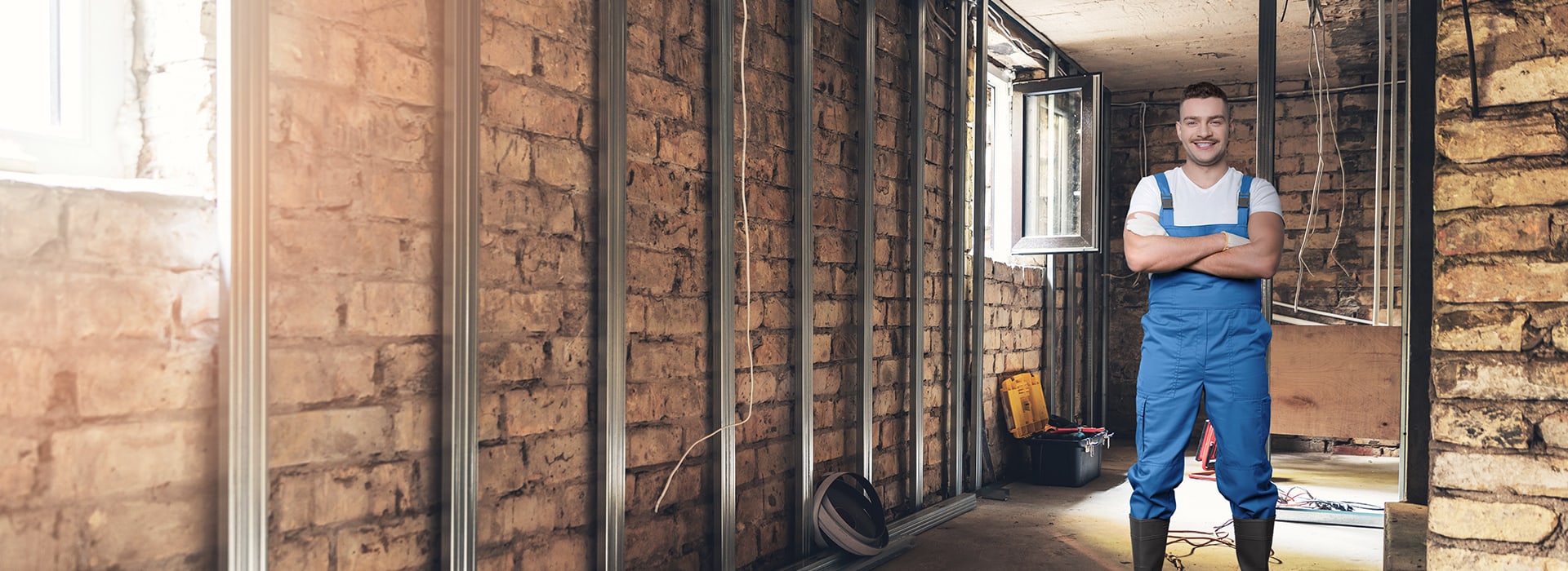 Man with overall in a building shell